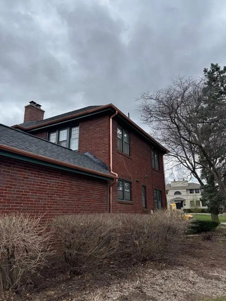 Custom half round copper gutters and twisted downspouts — photo 6