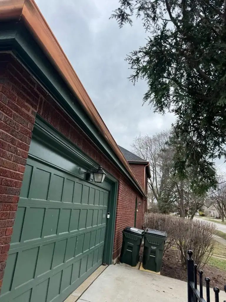 Custom half round copper gutters and twisted downspouts — photo 5