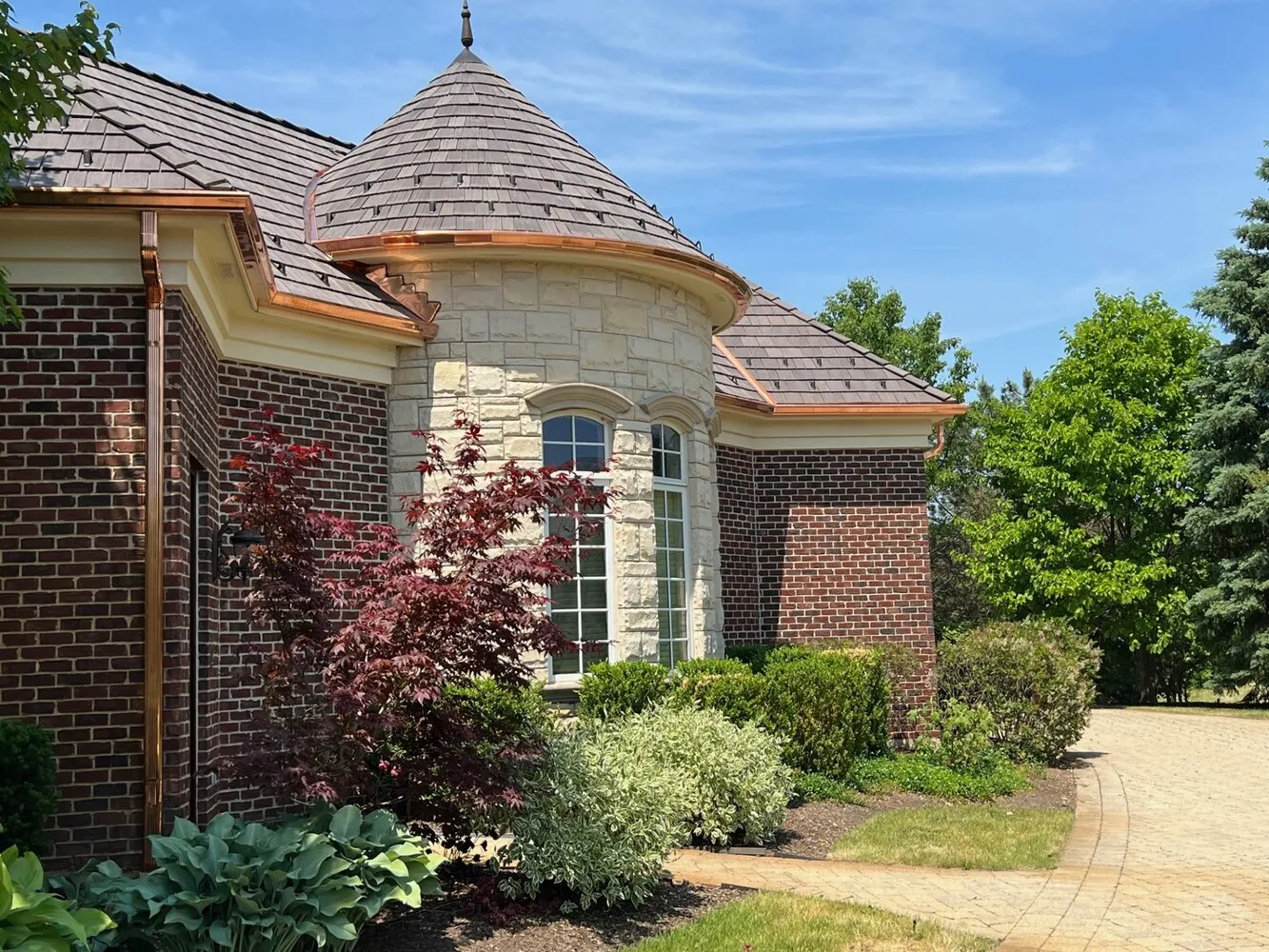 Copper gutters on luxury stone home with turret