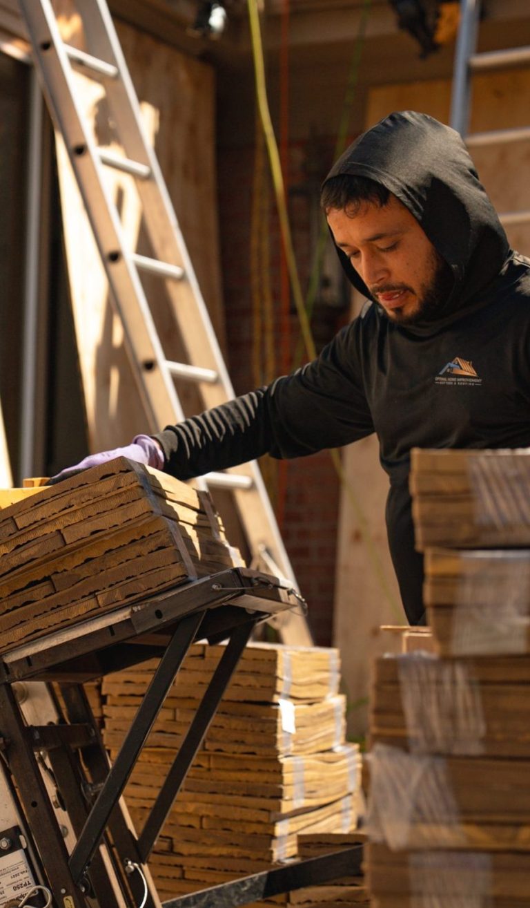 Installer preparing cedar shingles