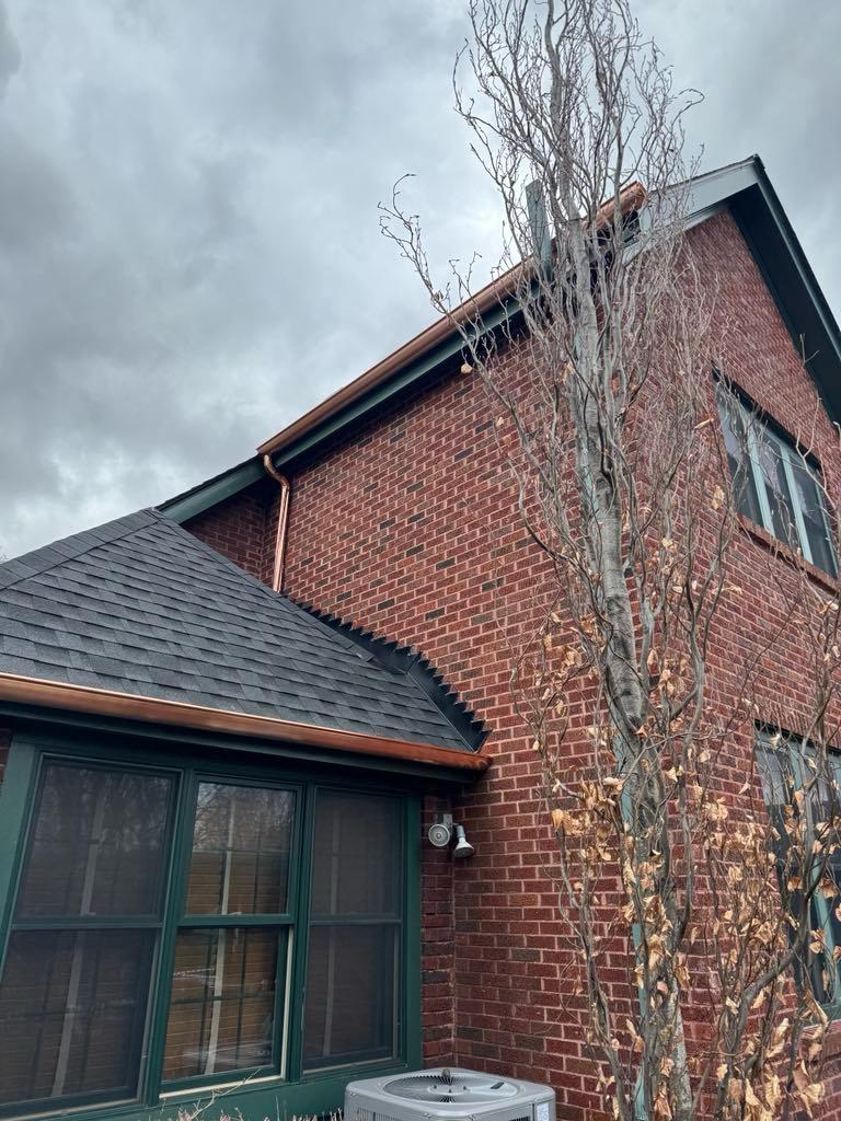 Copper gutters and downspout on brick tudor