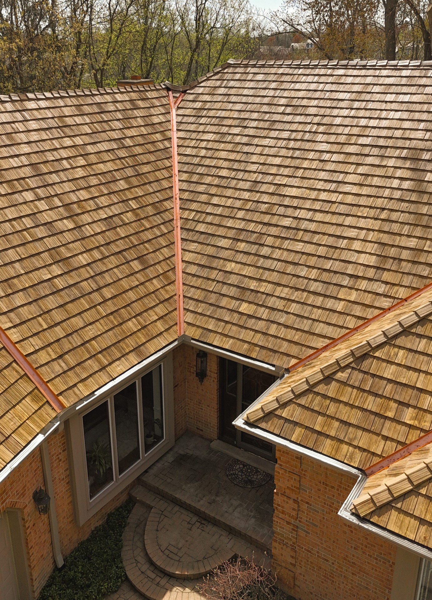 Cedar-look composite tiles with copper valleys