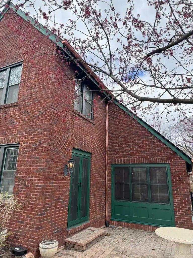 Custom half round copper gutters and twisted downspouts — photo 10