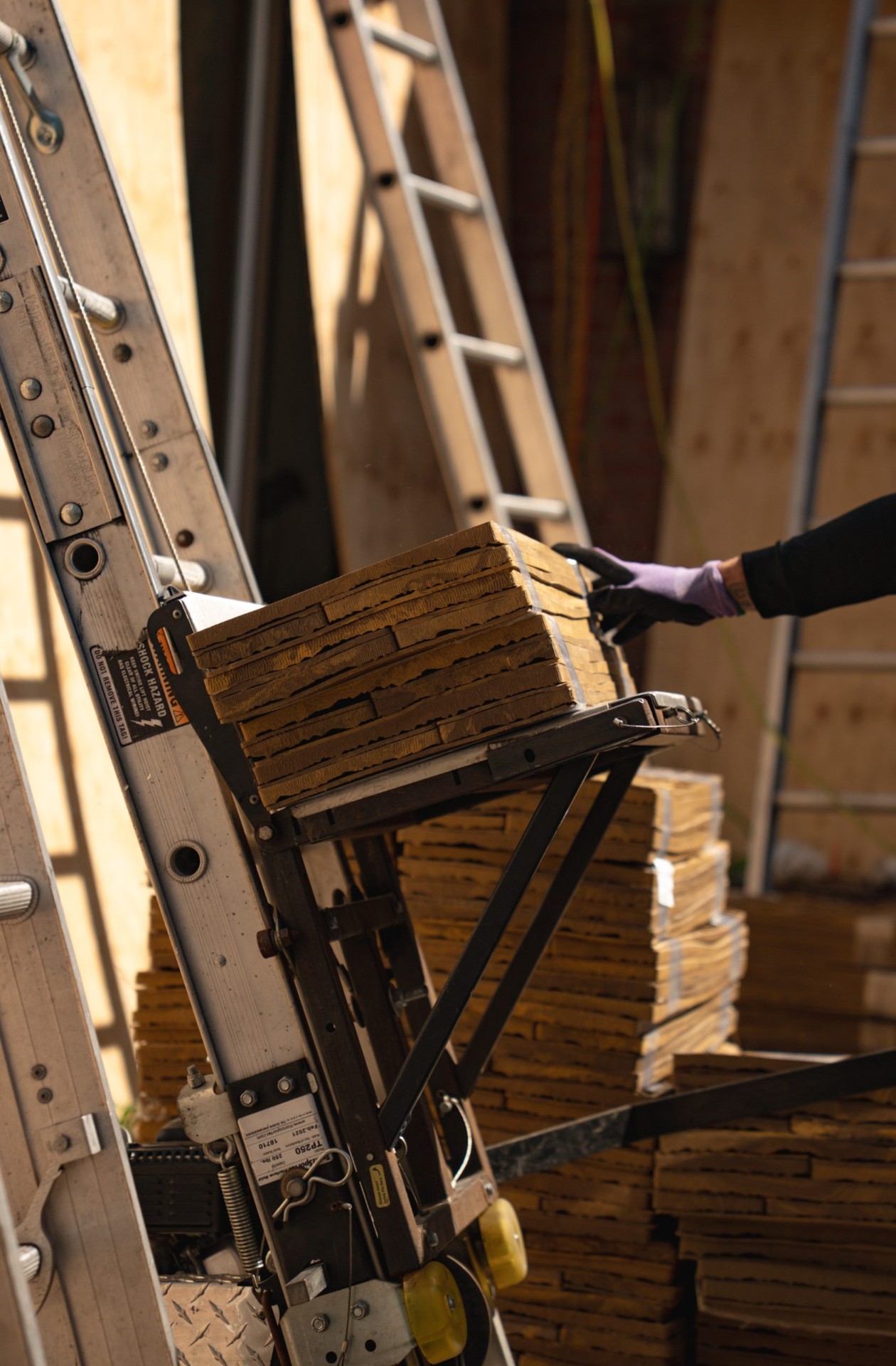 Close-up of composite shake bundles on ladder lift
